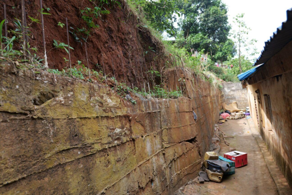 A retaining wall under construction at the back of Bintu's house, Photo credit: Ishmail Conteh